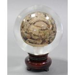A Chinese inside painted large glass orb decorated with an extensive view of a bustling city with
