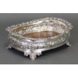 A William IV silver oblong dish with foliate embossed sides & cast vine rim, on four short scroll