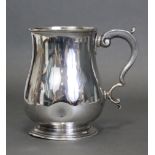 A George V silver tankard of baluster shape with scroll handle & on round pedestal foot, London 1912