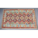 A Choli kelim vegetable-dye rug with all-over multicoloured geometric design within a wide border;