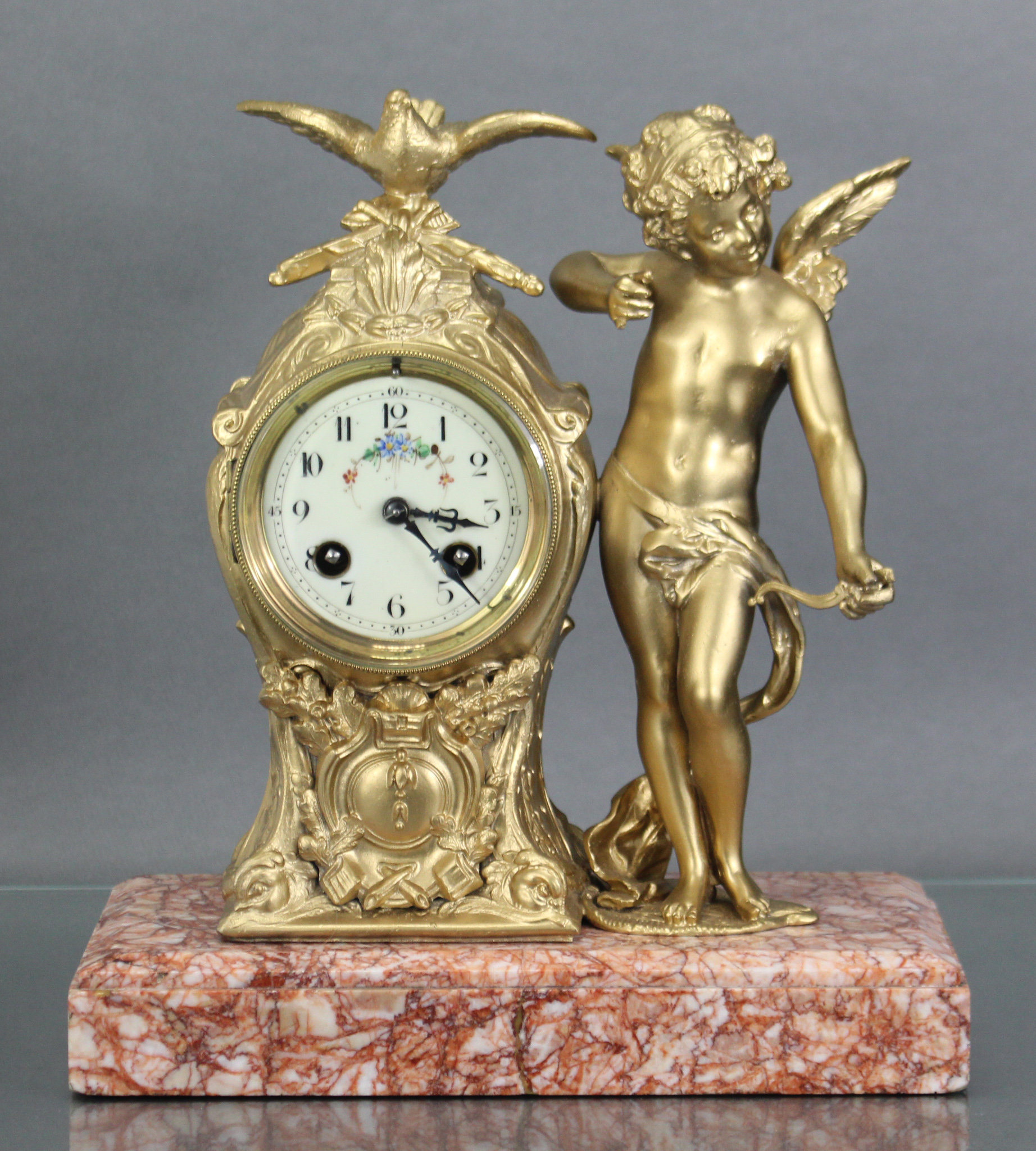 A 19th century French figural mantel clock, the 3” enamel dial with floral decoration & arabic