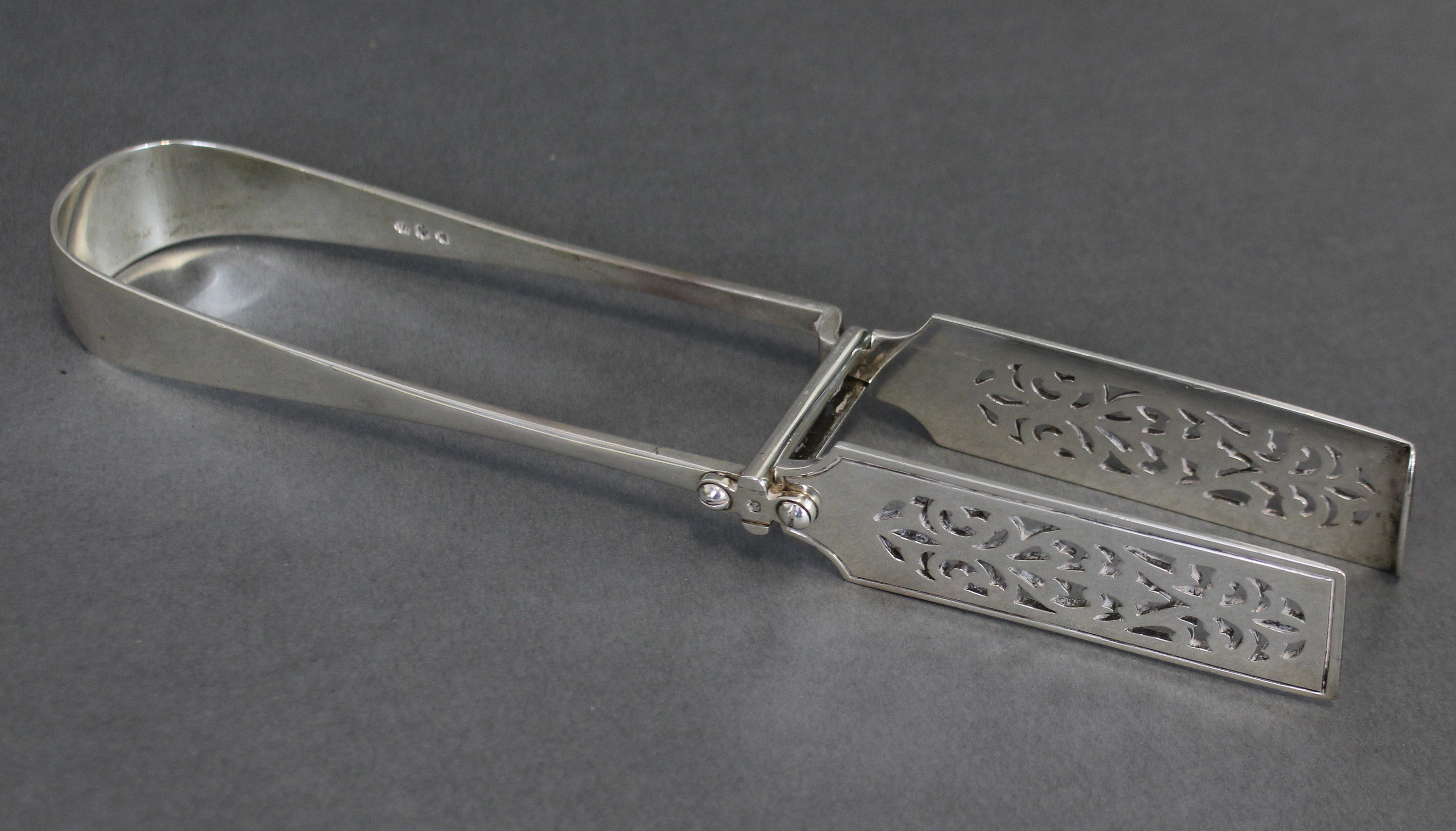 A pair of Victorian silver serving tongs with pierced rectangular blades, 10” long; London 1893, - Image 2 of 4