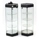 A pair of modern illuminated hexagonal display cabinets, each with three revolving circular