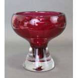 A 20th century cranberry glass bowl, the thick squat round body on heavy clear glass tapering