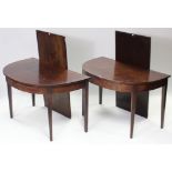 A Georgian mahogany extending dining table with d-shaped ends, two additional leaves, & on eight