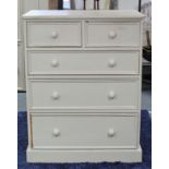 A white painted pine upright chest fitted two short & three long graduated drawers with turned