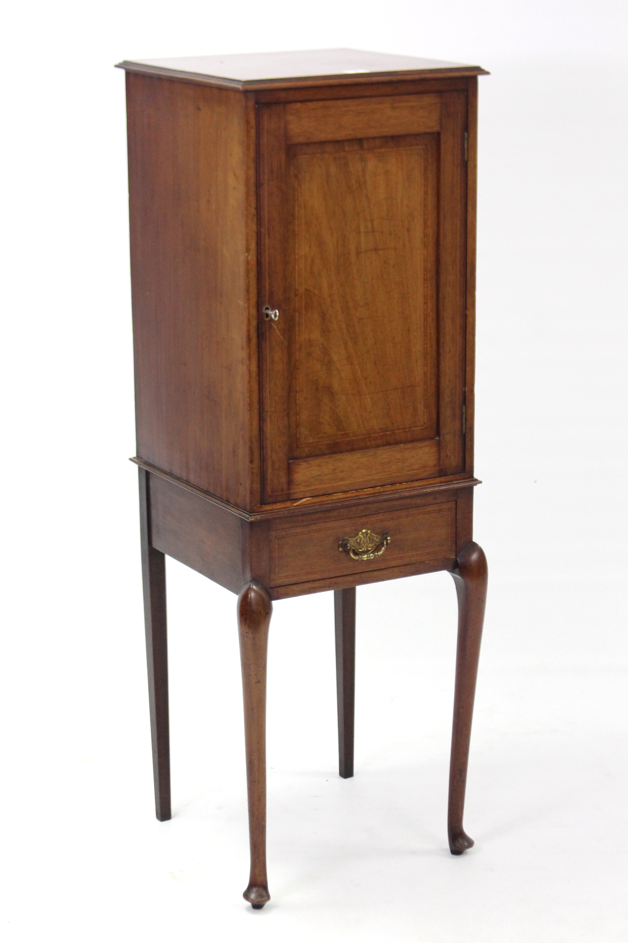 An Edwardian inlaid-mahogany small upright cabinet with fitted interior enclosed by panel door above