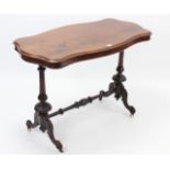 A Victorian rosewood centre table with moulded edge to the shaped rectangular top, & on vase-