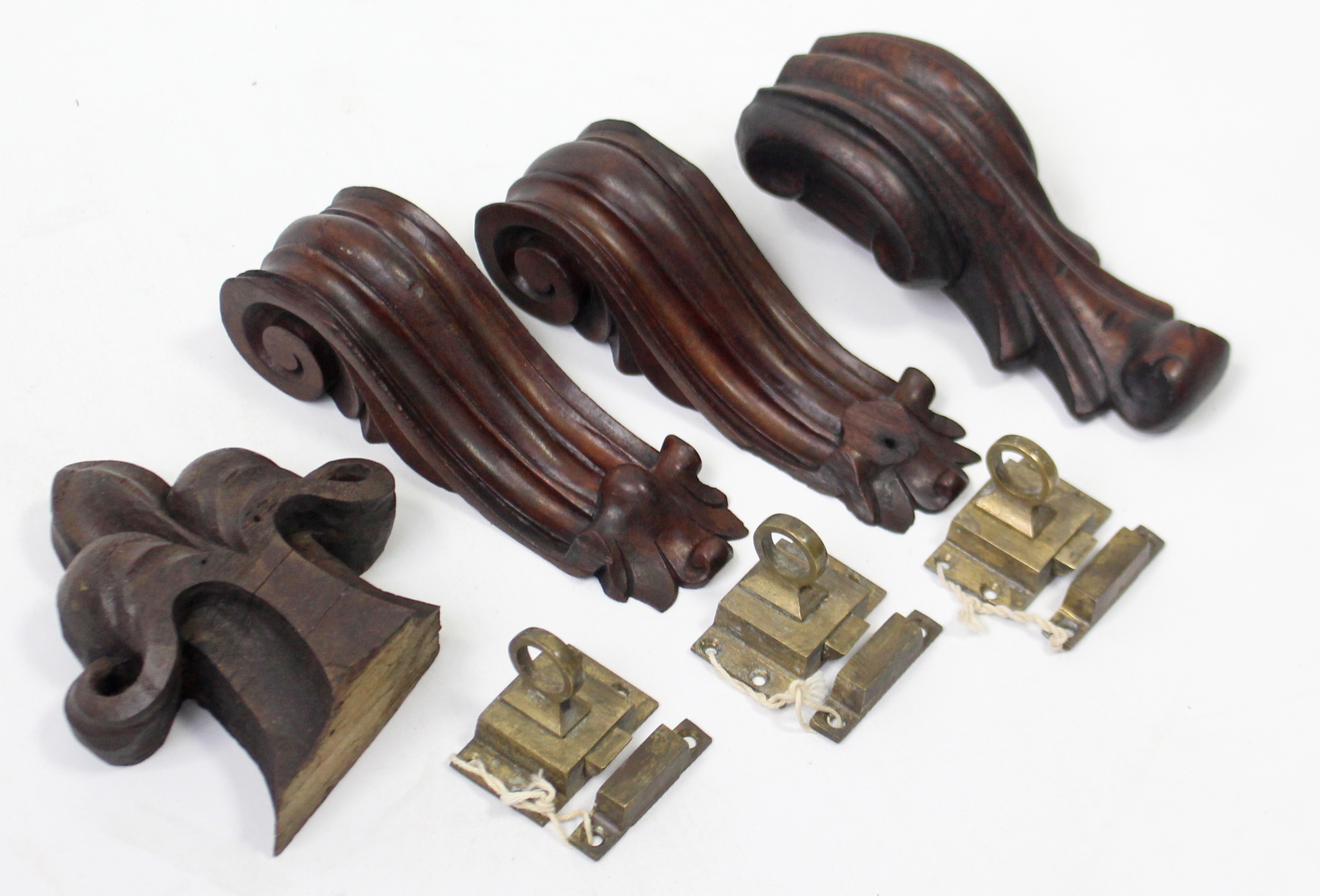 Four carved wooden appliques; & three brass furniture fittings.
