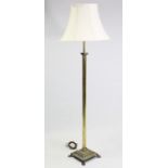 A brass Corinthian-style standard lamp, with shade.