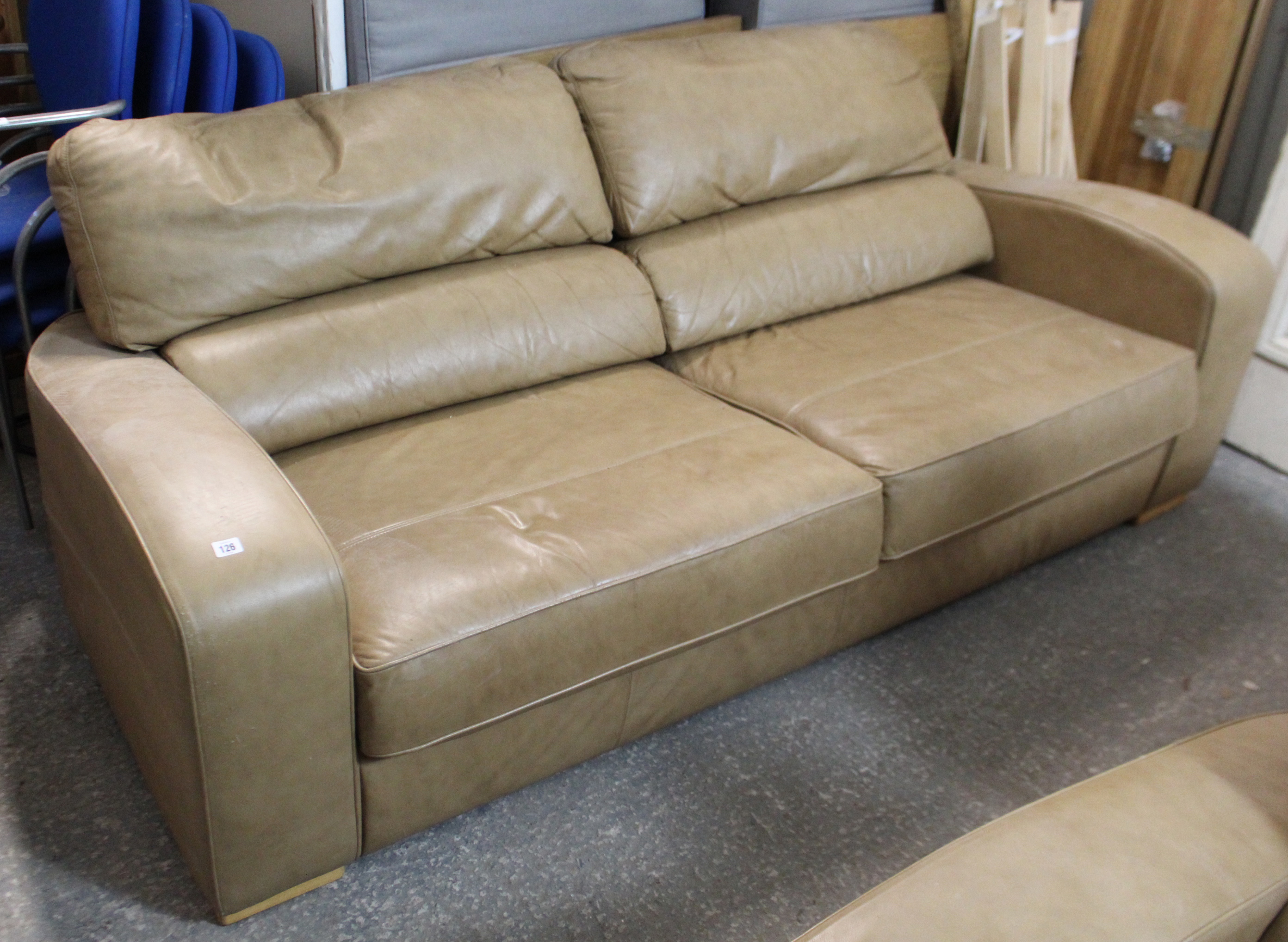 A tan leather three seater settee, 65” long; & a ditto two-seater settee, 84” long.