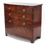 An early 19th century mahogany bow-front chest fitted two short & three long graduated drawers