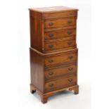 A reproduction yew wood small chest-on-chest fitted six long drawers with brass swing handles, &