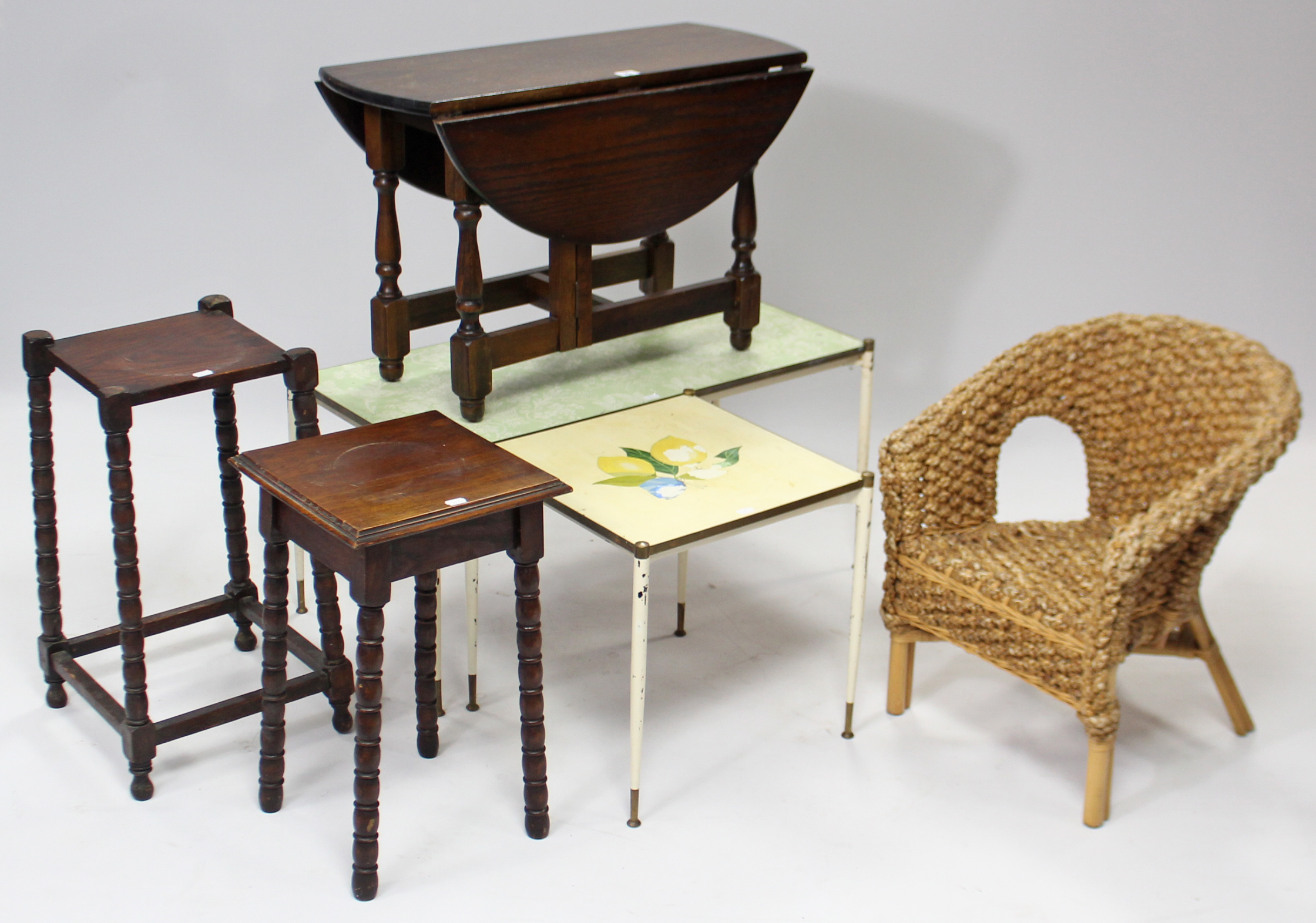 An oak circular drop-leaf low occasional table on baluster-turned legs with plain stretchers, 28½”