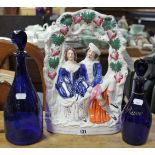 A Staffordshire pottery flat-back romantic figure group, 13¾” high; two blue glass decanters; &