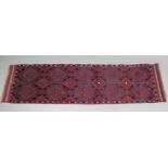 A Meshwari runner of madder ground, with all-over repeating geometric design in dark blue & ivory,