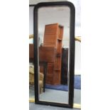 A large rectangular wall mirror in black-finish frame, with rounded top, & with beaded inner slip,