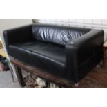 A black leather three-seater settee, 70” long.