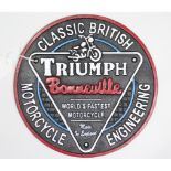 A reproduction painted cast-iron circular sign “TRIUMPH CLASSIC BRITISH MOTORCYCLE ENGINEERING”, 9½”