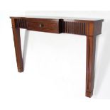 A mahogany break-front console table, fitted centre frieze drawer & on square supports, 53” wide x