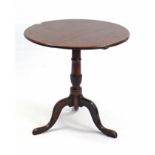 An 18th century oak & mahogany tripod table, with circular tilt-top on turned & spiral-fluted centre