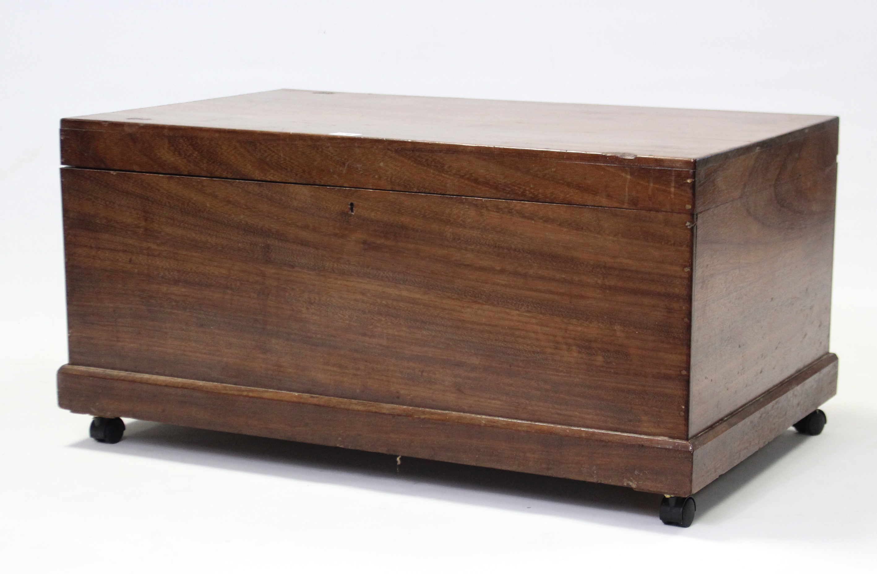 A mahogany storage trunk with hinged lift lid, 31” wide x 15½” high.