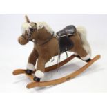 A Mamas & Papas cloth-covered rocking horse, 34” long x 29” high.