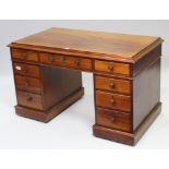 A Victorian mahogany pedestal desk with moulded edge to the rectangular top, & fitted with an