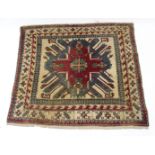 A Persian pattern rug of ivory & crimson ground with geometric design to centre within a multiple