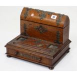 A late Victorian oak desk inkstand with brass fittings (lacking inkwells), 12” wide x 9¾” high.