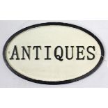 A reproduction painted cast-iron oval sign: “ANTIQUES”, 8¼” x 13¼”.