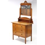 An Edwardian walnut small dressing chest, with rectangular swing mirror to the stage back, fitted