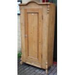 A continental-style tall pine hall cupboard with shaped & moulded cornice, & having fitted