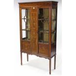 An Edwardian inlaid-mahogany tall china display cabinet, fitted two shelves enclosed by pair of