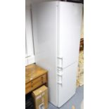 A Liebherr upright fridge-freezer in white finish case, 21” wide x 70¾” high.