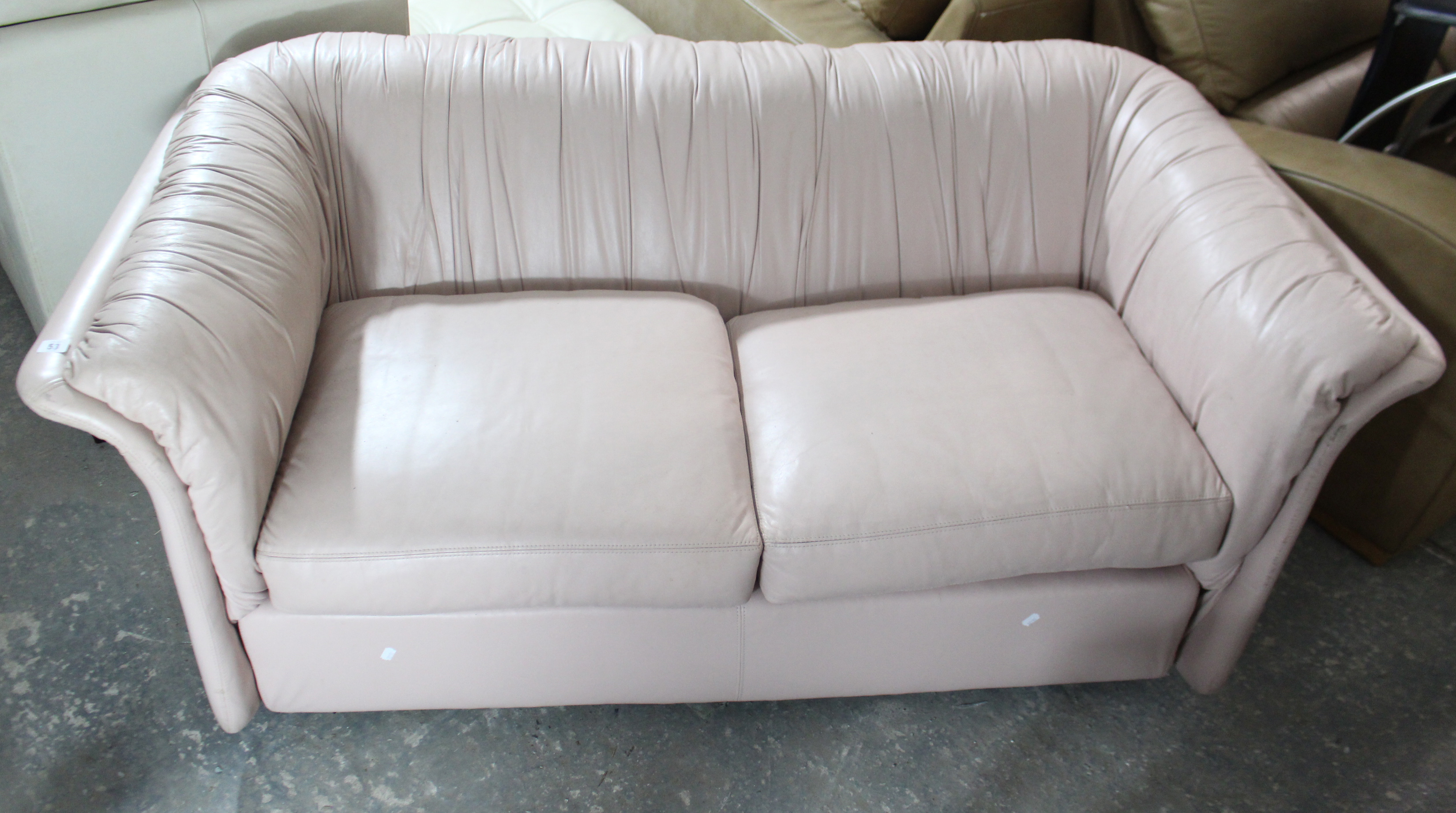 An Emerson pale pink leather two-seater settee, 66” long.