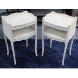 A pair of continental-style white painted wooden tray-top two-tier bedside tables, each on four