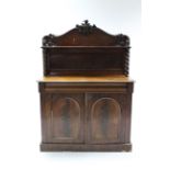 A Victorian mahogany chiffonier with stage back & shelf, on turned supports, fitted one frieze