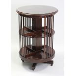 A reproduction mahogany cylindrical three-tier revolving bookcase, 24” diam. x 35” high.