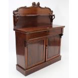 A Victorian mahogany chiffonier with open shelf to the low-stage panel back, fitted frieze drawer