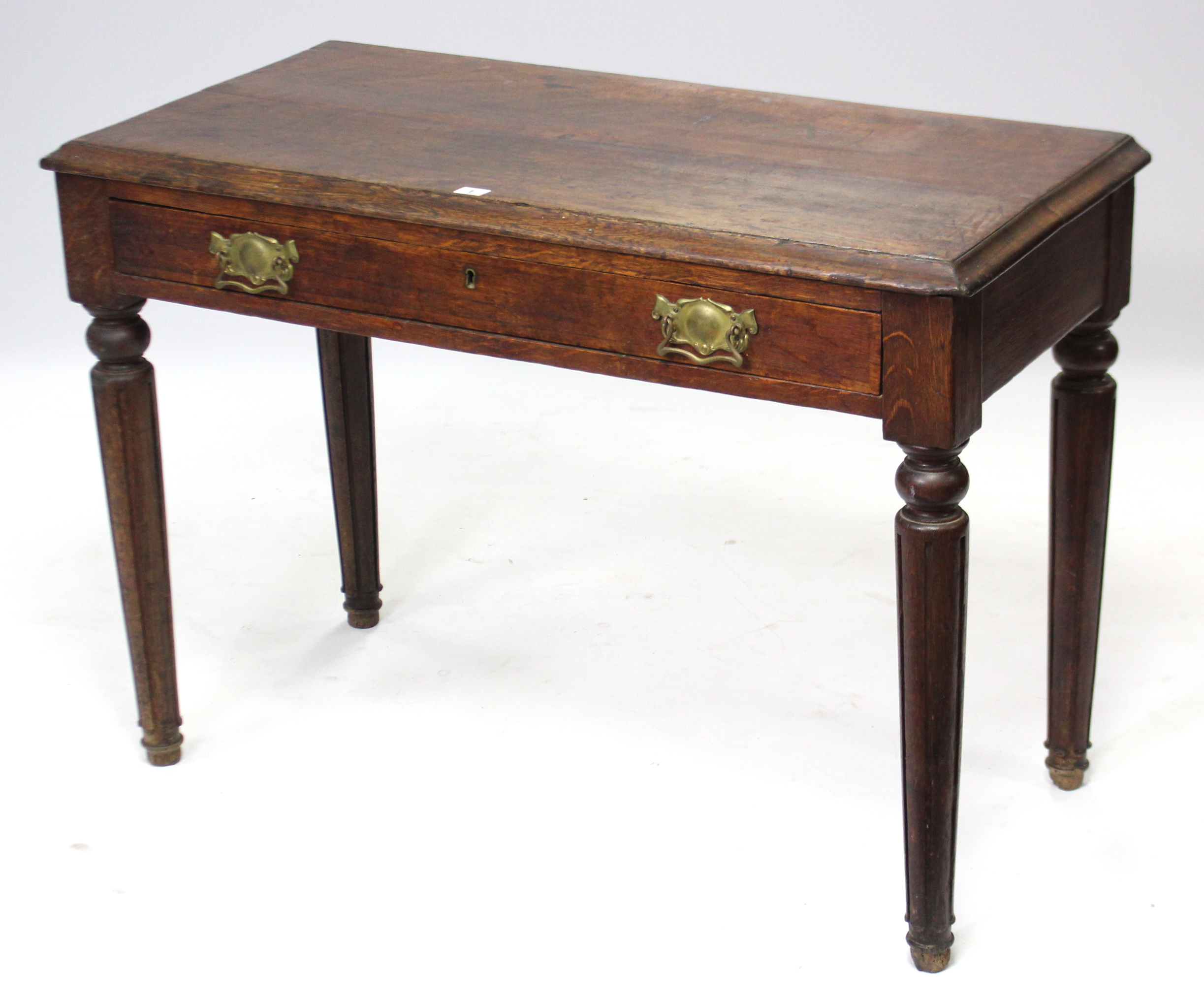 A late Victorian oak side table with moulded edge to the rectangular top, fitted frieze drawer, & on