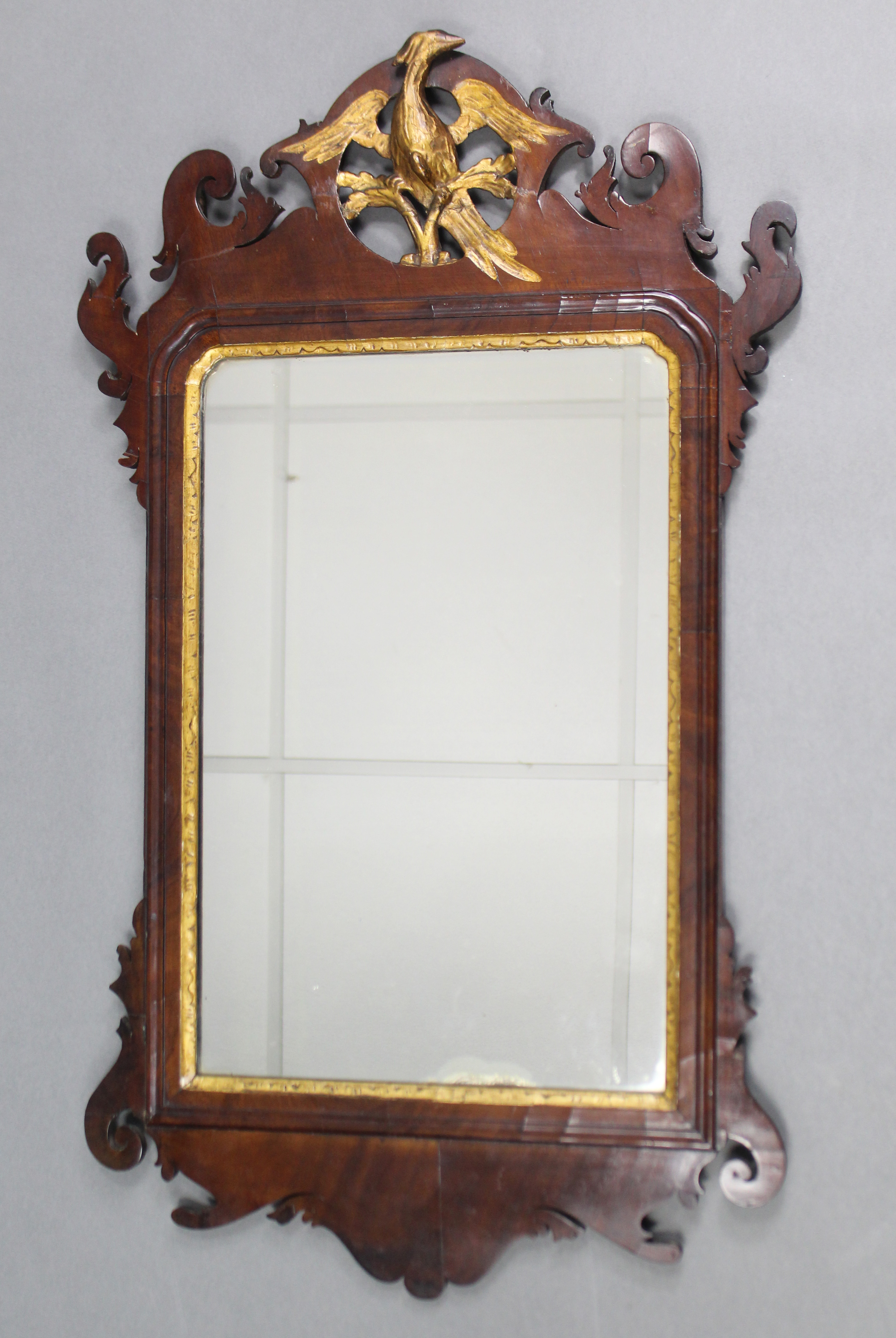 A 19th century mahogany Swansea-type rectangular wall mirror in fret-carved scroll frame with gilt