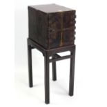 A Chinese lacquered table cabinet, fitted with an arrangement of six drawers enclosed by panel door,
