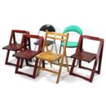 Ten various fold-away chairs.