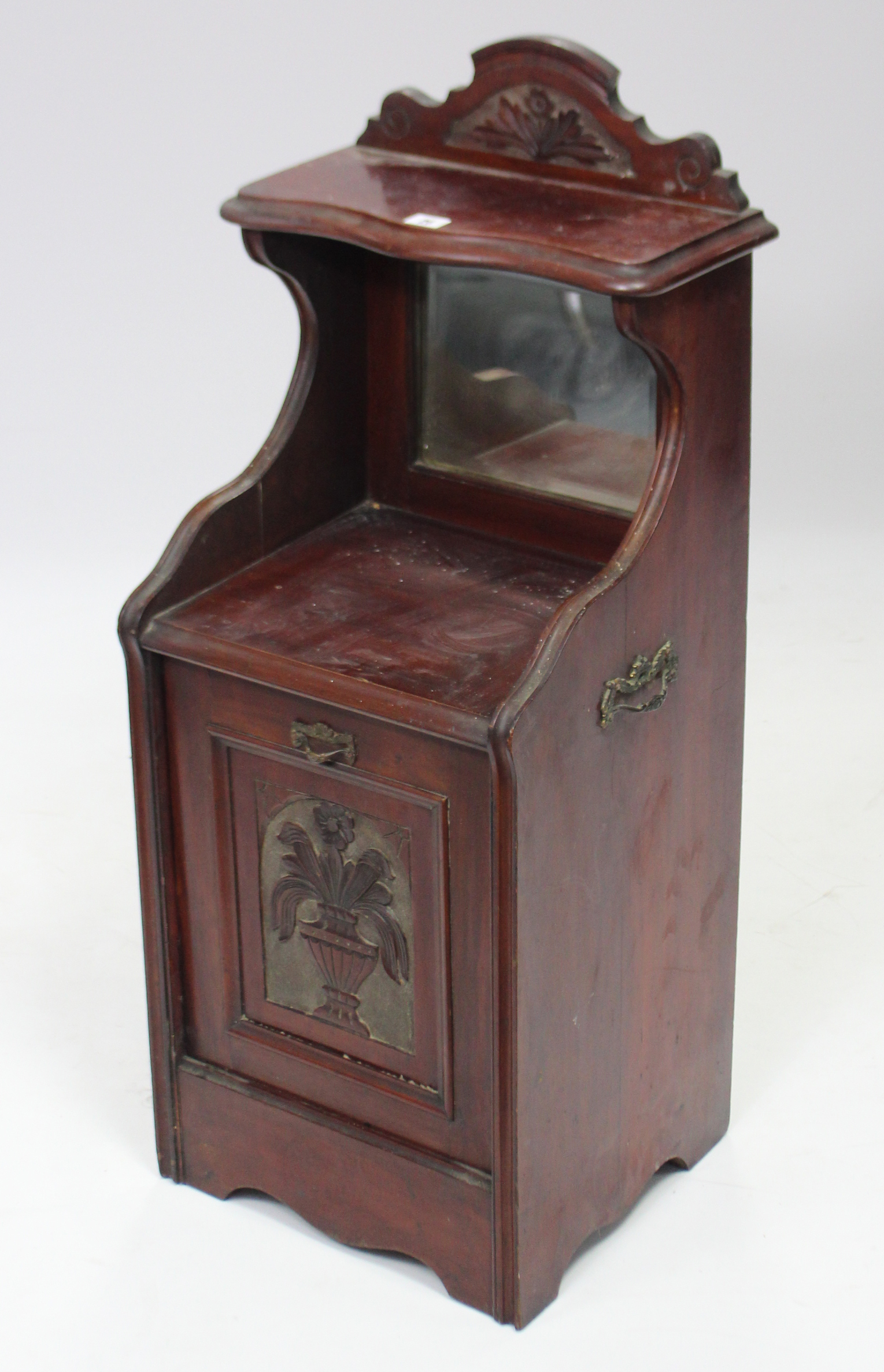 A late Victorian mahogany purdonium enclosed by carved panel door, 16¾” wide x 39” high.