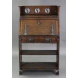An Arts & Crafts oak upright hall cabinet, with pierced roundels to the tray top & sides, a