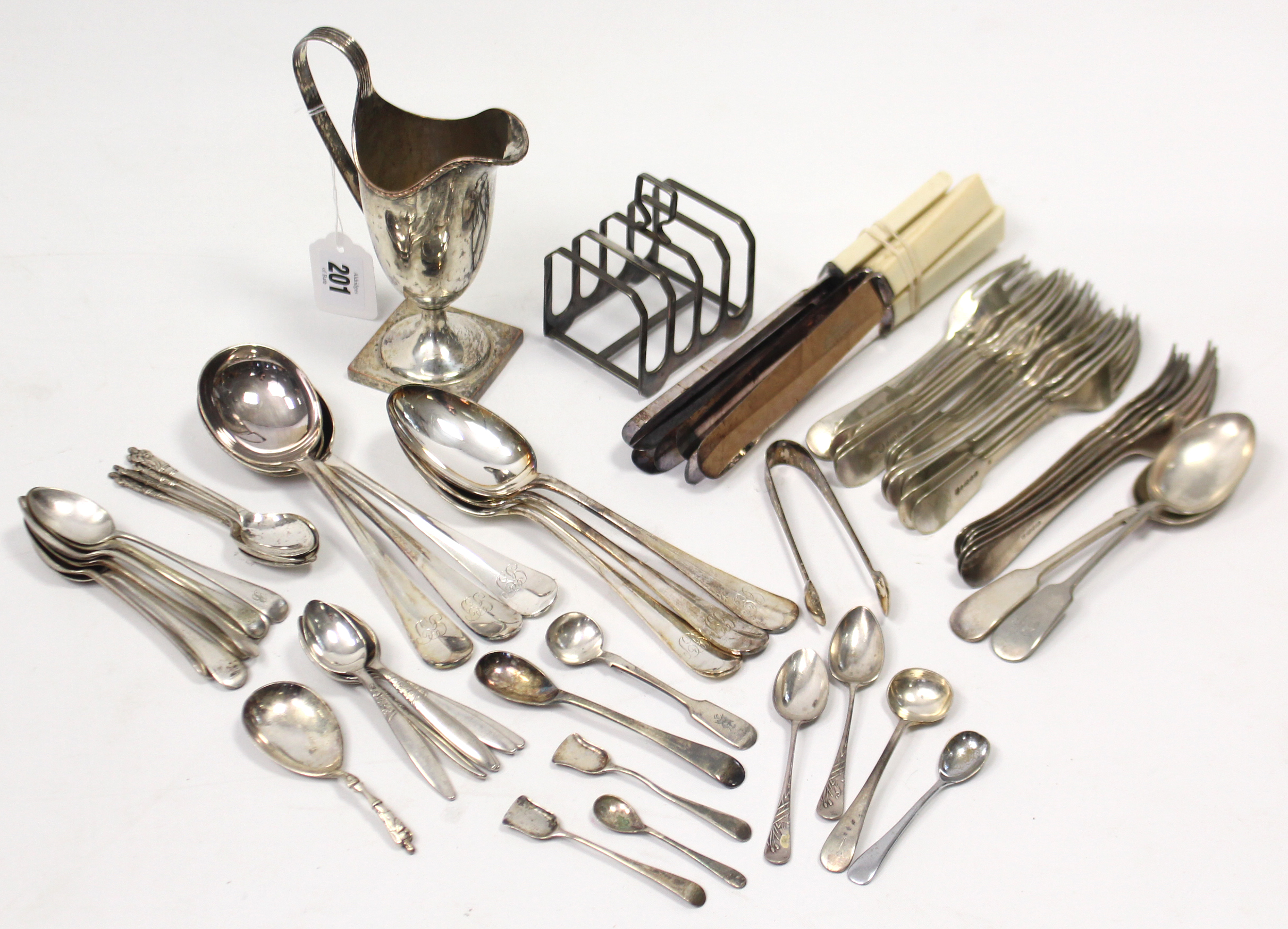 A silver plated helmet-shaped cream jug, 5½” high; a silver-plated four-division toast rack; &