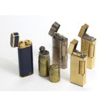 Three Dunhill cigarette lighters; a Cartier cigarette lighter; & a WWI trench cigarette lighter.