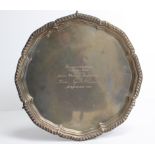 A 1960's silver salver with gadrooned edge, inscription to centre, & on three scroll feet, (
