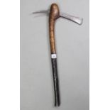 An ethnic carved hardwood axe with engraved steel head, 24” long.